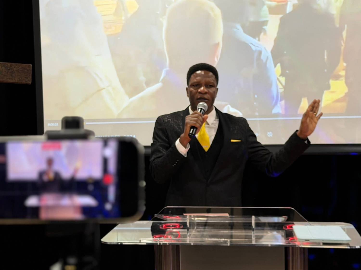 Pastor Brawn Obaweki preaching at EBM